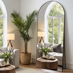 a living room filled with furniture and a large mirror on top of a wooden table