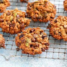 several cookies cooling on a wire rack, with nuts and chocolate chips in the middle