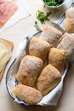 bread rolls on a plate with text overlay saying how to make no bread ciabatta rolls