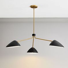 three lights hanging from the ceiling in a room