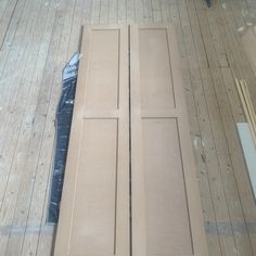 an unfinished cabinet door is laying on the floor