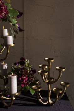 candles and flowers are arranged on a table