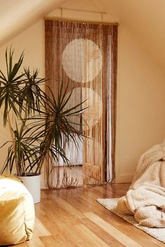 a bedroom with wooden floors and a plant in the corner