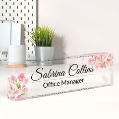 there is a sign that says sahrina collins office manager on the desk