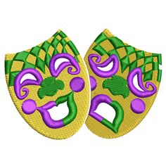 two masks with purple and green designs on them