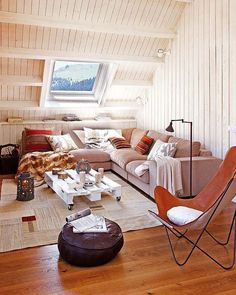 a living room filled with furniture and a skylight