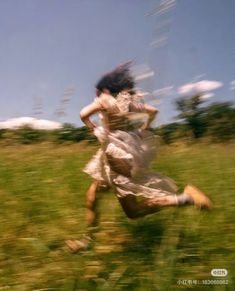 a blurry photo of a woman running in the grass