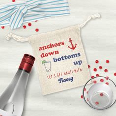 an anchor's down bottom bottoms up tea towel next to a bottle of wine