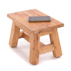 a small wooden stool with a remote control on it's end table, against a white background