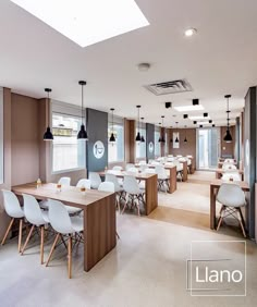 the dining room is clean and ready for guests to eat at it's long tables