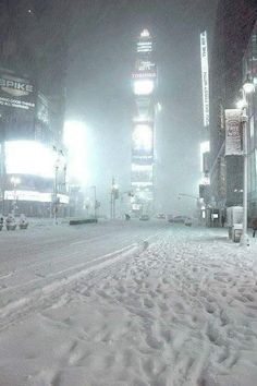 a city street covered in snow at night