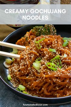 a bowl filled with noodles and vegetables on top of a table