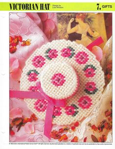 a cross stitch pattern for a hat with pink flowers on the front and side,