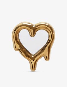 a gold heart shaped brooch on a white background