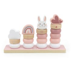 a set of wooden toys with animals and clouds on top of each other, including an egg