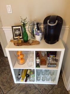 a white shelf with drinks and other items on it