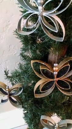 a christmas tree decorated with ribbons and bows on it's branches, in the shape of an ornament