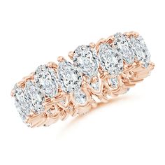 a rose gold ring with five pear shaped diamonds in the center and an intricate band