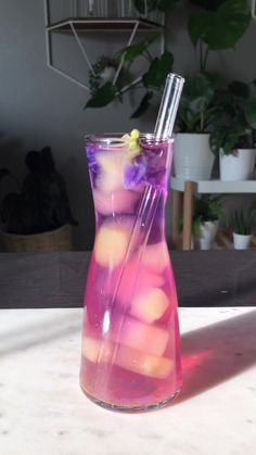 a pitcher filled with liquid sitting on top of a table