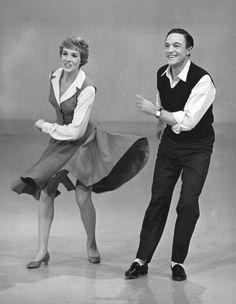 an old photo of two people dancing