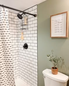 a white toilet sitting next to a shower in a bathroom