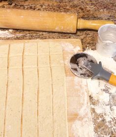 the dough is ready to be cut and put into squares with a rolling pin next to it