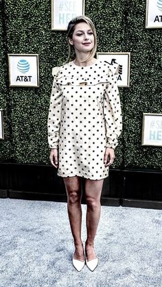 a woman standing on top of a blue carpet