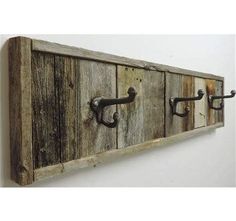 an old wooden coat rack with three hooks