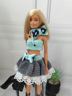 the doll is wearing a crocheted skirt and crop top