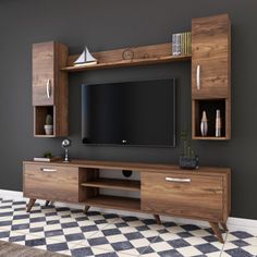 an entertainment center with bookshelves and a flat screen tv mounted on the wall