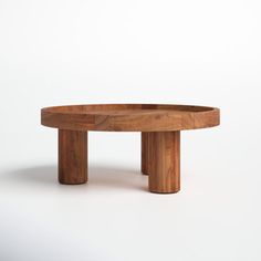 a round wooden table with two legs on the top and one leg in the middle