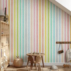 a child's room with multicolored wallpaper and wooden table in the corner