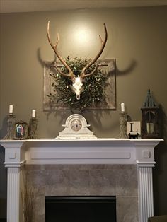 a fireplace with a deer's head mounted on the mantle