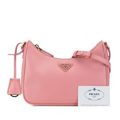 Product Details: Pink Prada Mini Saffiano Re Edition Shoulder Bag. This shoulder bag features a saffiano leather body, an adjustable flat leather strap, and a top zip closure. 5.1" L x 8.7" W x 2.4" D, 8.3" drop. Serial number 1BC204. Condition: Pre-owned. Very Good. Exterior Back Worn. Exterior Back stained with Other. Lock Scratched. Exterior Corners Worn. Embellishment Scratched. Exterior Handle Worn. Exterior Handle stained with Other. Practical Attachment Scratched. Exterior Top Worn. Zipper Scratched. Please note this is a pre-owned item that may display signs of wear consistent with the condition listed above and shown in photos. Designer Revival guarantees this is an authentic Pink Prada Mini Saffiano Re Edition Shoulder Bag or 100% of your money back. Learn more about our authenti Pink Prada, Prada Mini, Display Signs, Prada Saffiano, Triangle Logo, Pink Leather, Pink Bag, Leather Shoulder Bag, Calf Skin