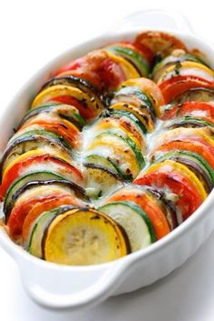 a casserole dish filled with sliced vegetables