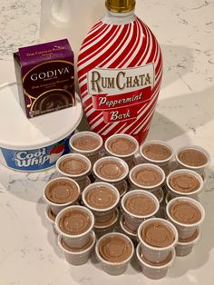 the ingredients to make chocolate pudding are displayed on a marble counter top, including a bottle of rumchata