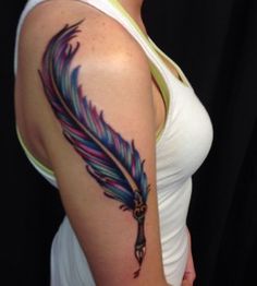 a woman with a tattoo on her arm and a feather in the shape of a cross