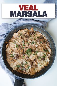 a pizza with mushrooms and parsley in a skillet on top of a table