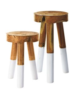 two stools made out of wood and white paint on the legs, each with different colors