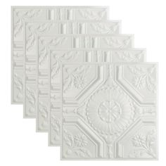 four white ceiling tiles with floral designs on them, all in different shapes and sizes