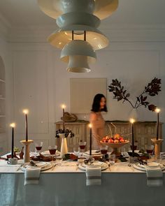 a woman standing in front of a table filled with food