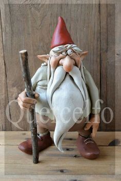 a statue of an old man holding a stick