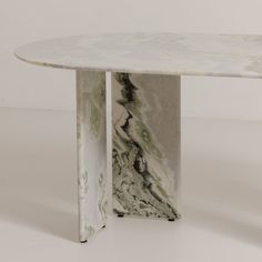 a marble table sitting on top of a white floor