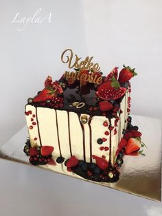 a white cake with chocolate and strawberries on top