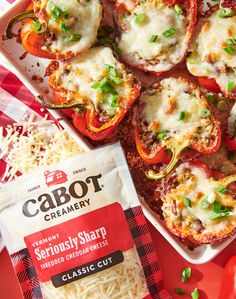 some stuffed bell peppers are on a red and white checkered table cloth next to a bag of crabot cremeery