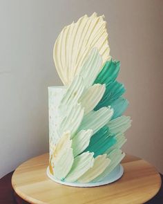 a white and green cake on top of a wooden table