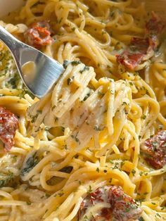 a fork is being used to eat some pasta