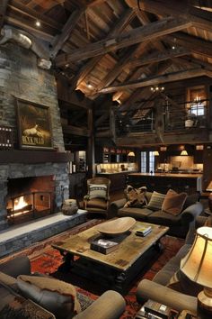 a living room filled with furniture and a fire place in the middle of a room