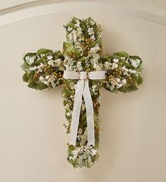 a floral cross hanging on the wall