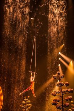 a man is suspended from a rope in the air with his hands and legs outstretched